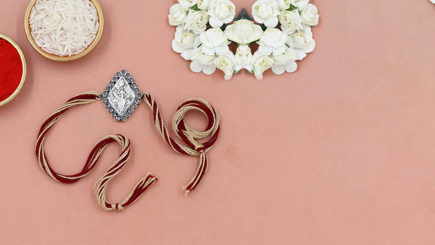"Floral Grace Rakhi in Antique Silver Finish"