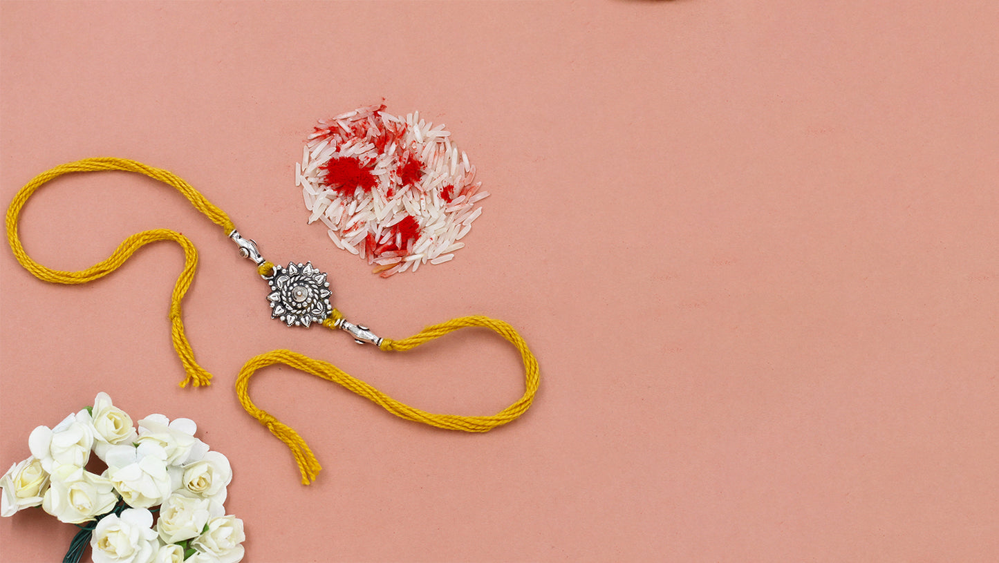 Floral Radiance Silver Rakhi by Sangeeta Boochra