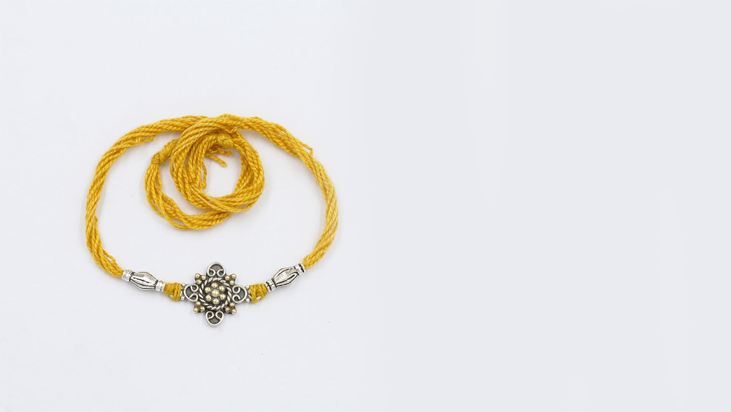 Intricate Silver Rakhi with us