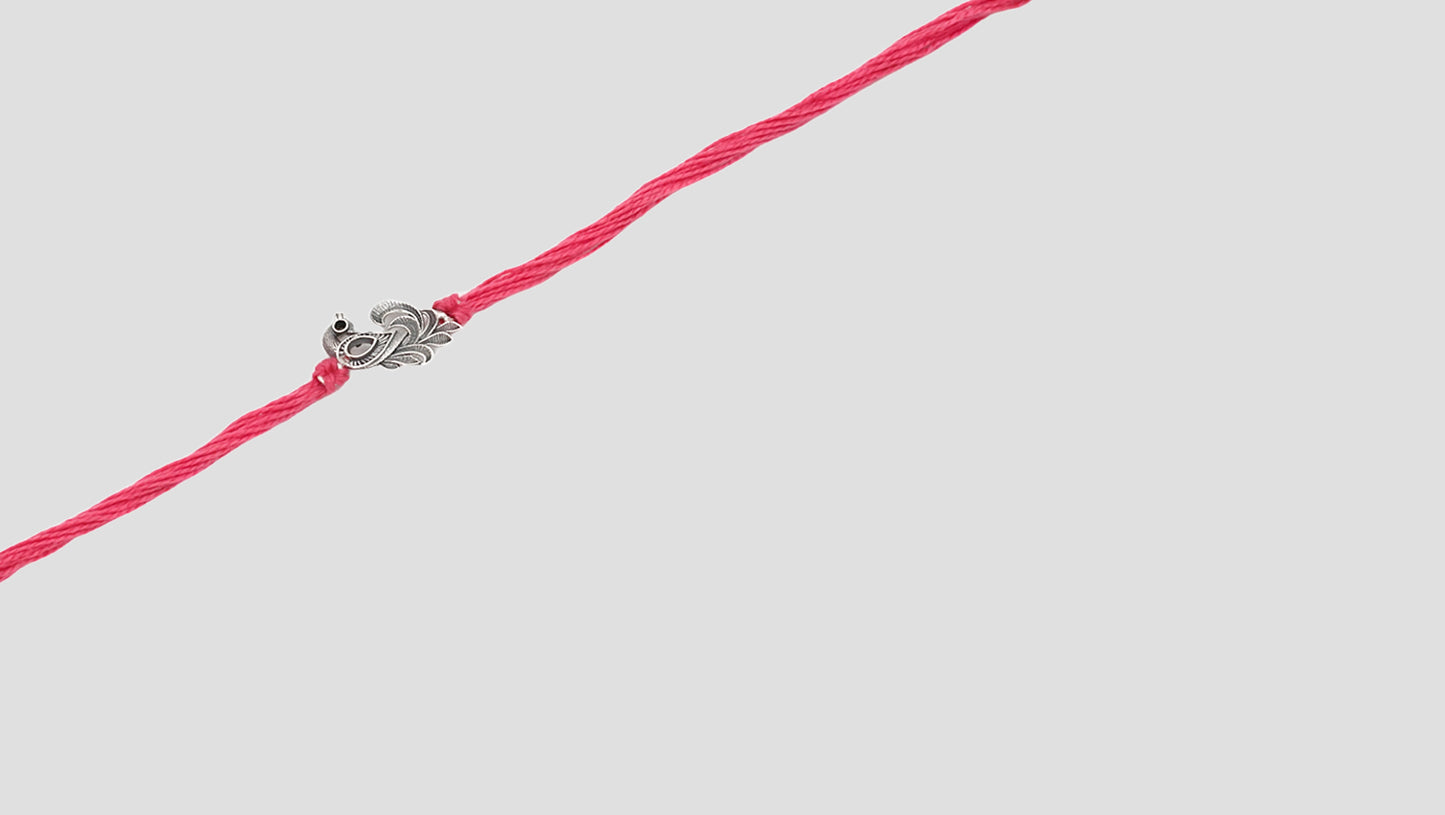 Peacock grace silver rakhi by Sangeeta Boochra