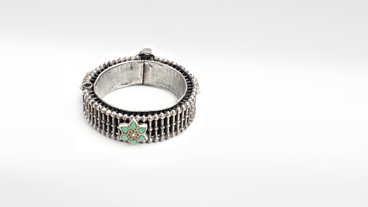 Silver Bangle with Kundan and Emerald Stone featuring intricate design