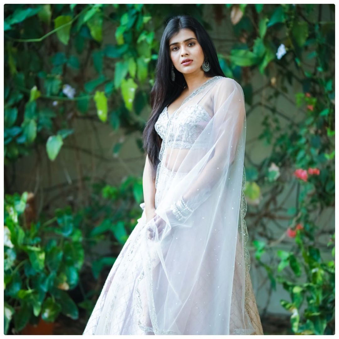 A Beautiful Indian Woman In White Saree Wearing Silver Earrings In Front Of  Mirror With Smiling Face Stock Photo, Picture and Royalty Free Image. Image  162074114.